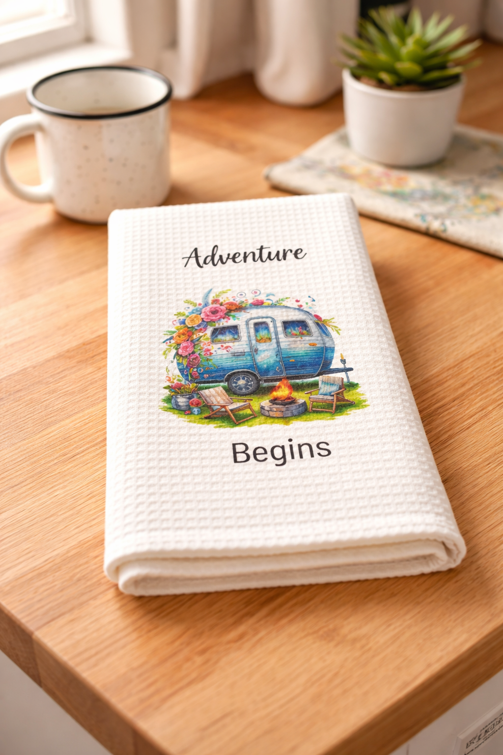 Blue camper kitchen towel with campfire and cozy chairs — feel-good outdoor adventure home décor