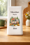 Vintage camper kitchen towel with pine trees, flowers, and campfire design — adventure-themed home décor