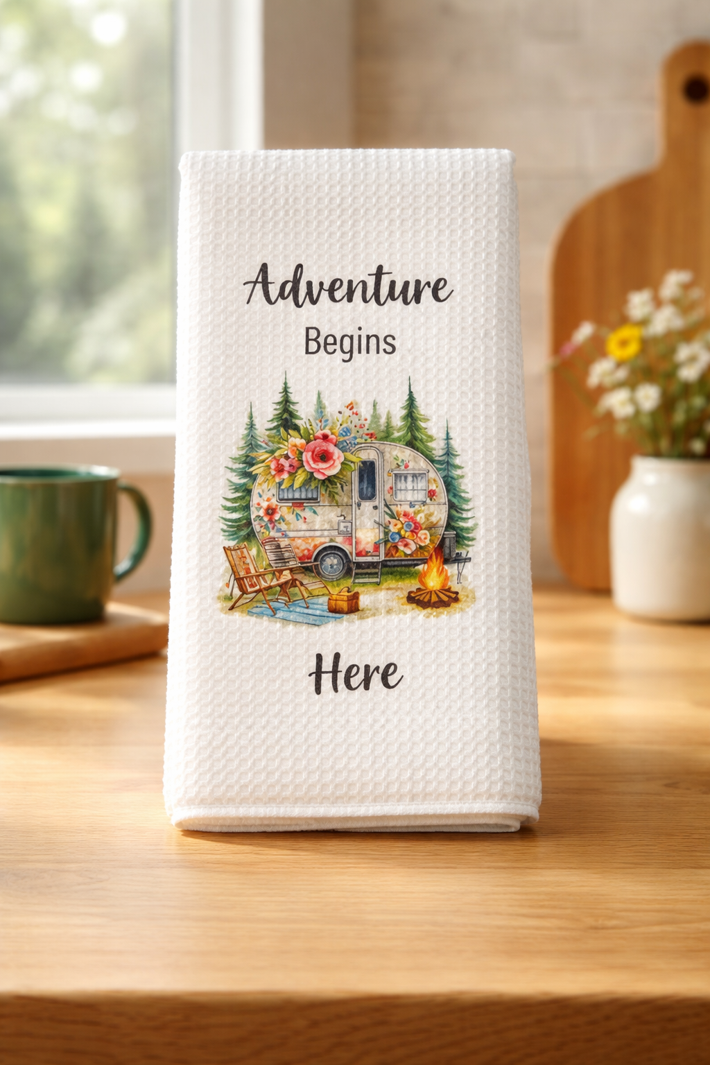 Vintage camper kitchen towel with pine trees, flowers, and campfire design — adventure-themed home décor